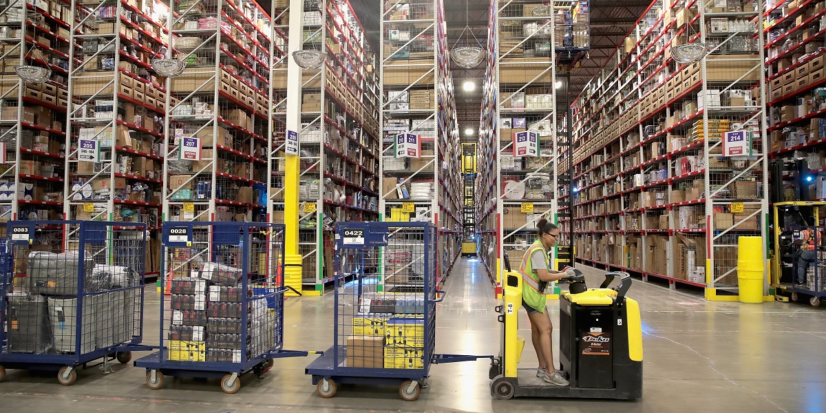 ROMEOVILLE, IL - AUGUST 01:  Workers pack and ship customer orders at the 750,000-square-foot Amazon fulfillment center on August 1, 2017 in Romeoville, Illinois. On August 2, Amazon will be holding job fairs at several fulfillment centers around the country, including the Romeoville facility, in an attempt to hire more than 50,000 workers.  (Photo by Scott Olson/Getty Images)
